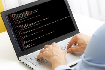 Coder using a laptop
