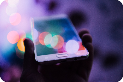 Mobile in hand with light reflecting off it