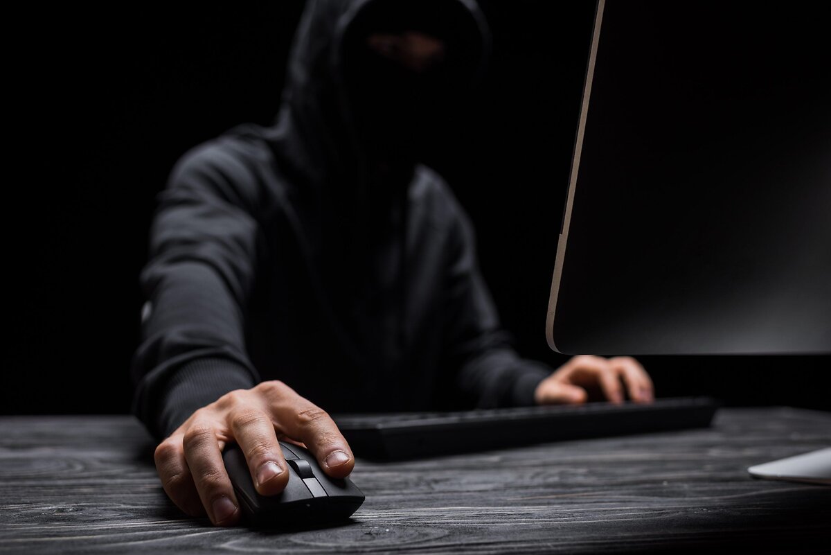 Shadowed Person Using Computer Mouse
