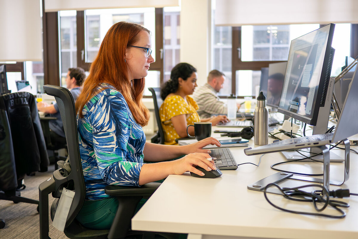 £ people with their computers at Envisage DIgital