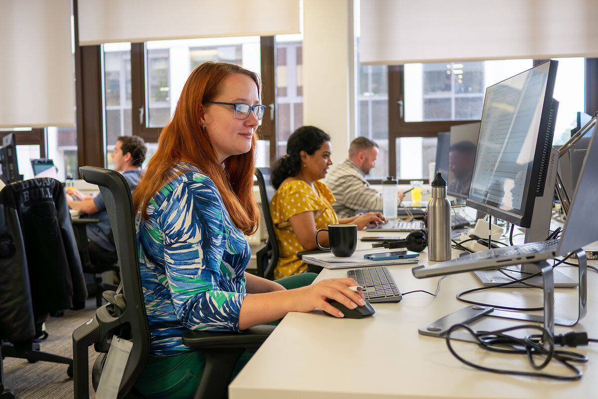 Women at a desk using a computer