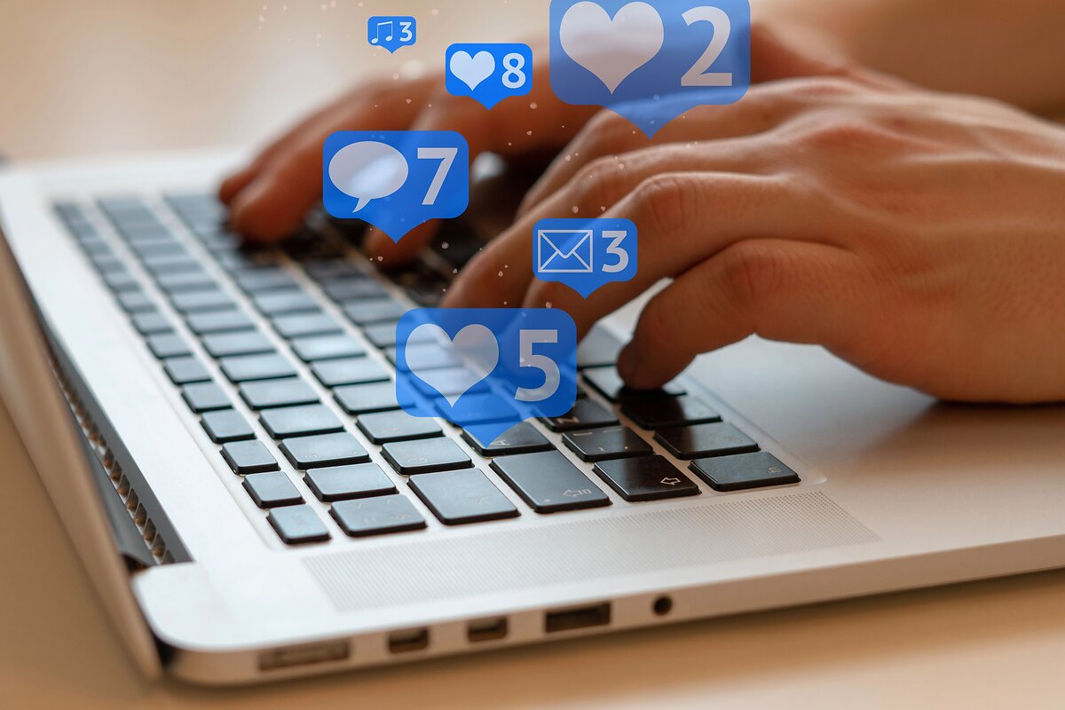 Laptop with floating heart emojis