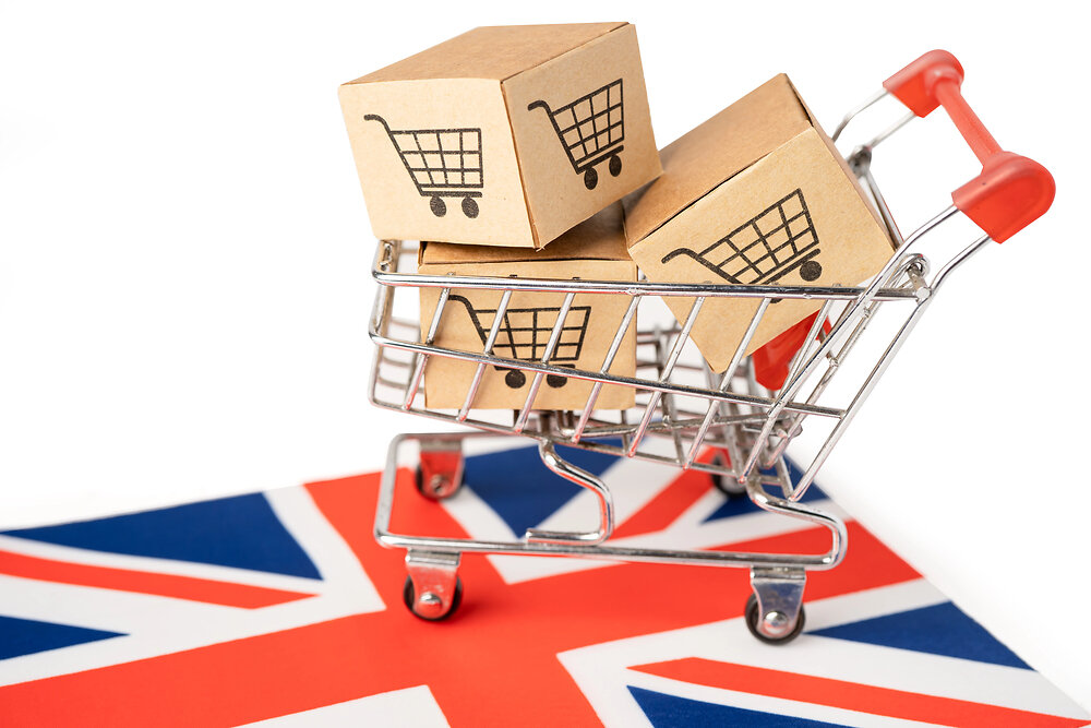 Box with shopping cart logo and United Kingdom flag, Import Export Shopping online or eCommerce finance delivery service store product shipping, trade, supplier concept.