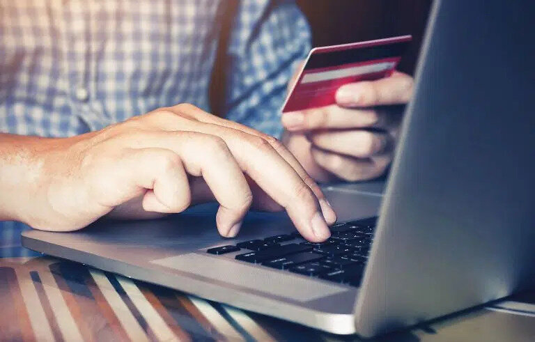 person using card to shop online