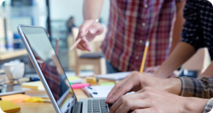 people reviewing work on laptop